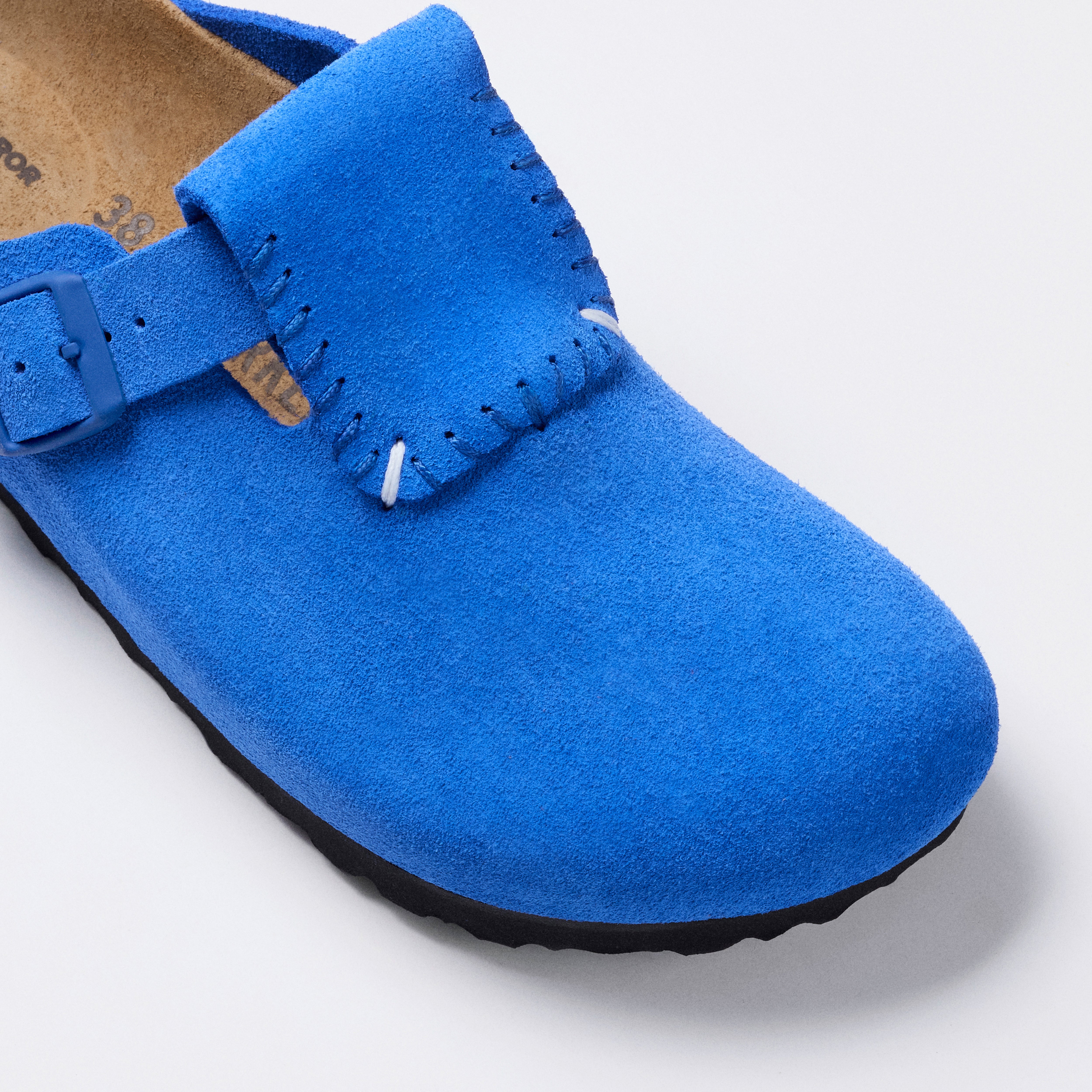 blue and black sandals on a white background 