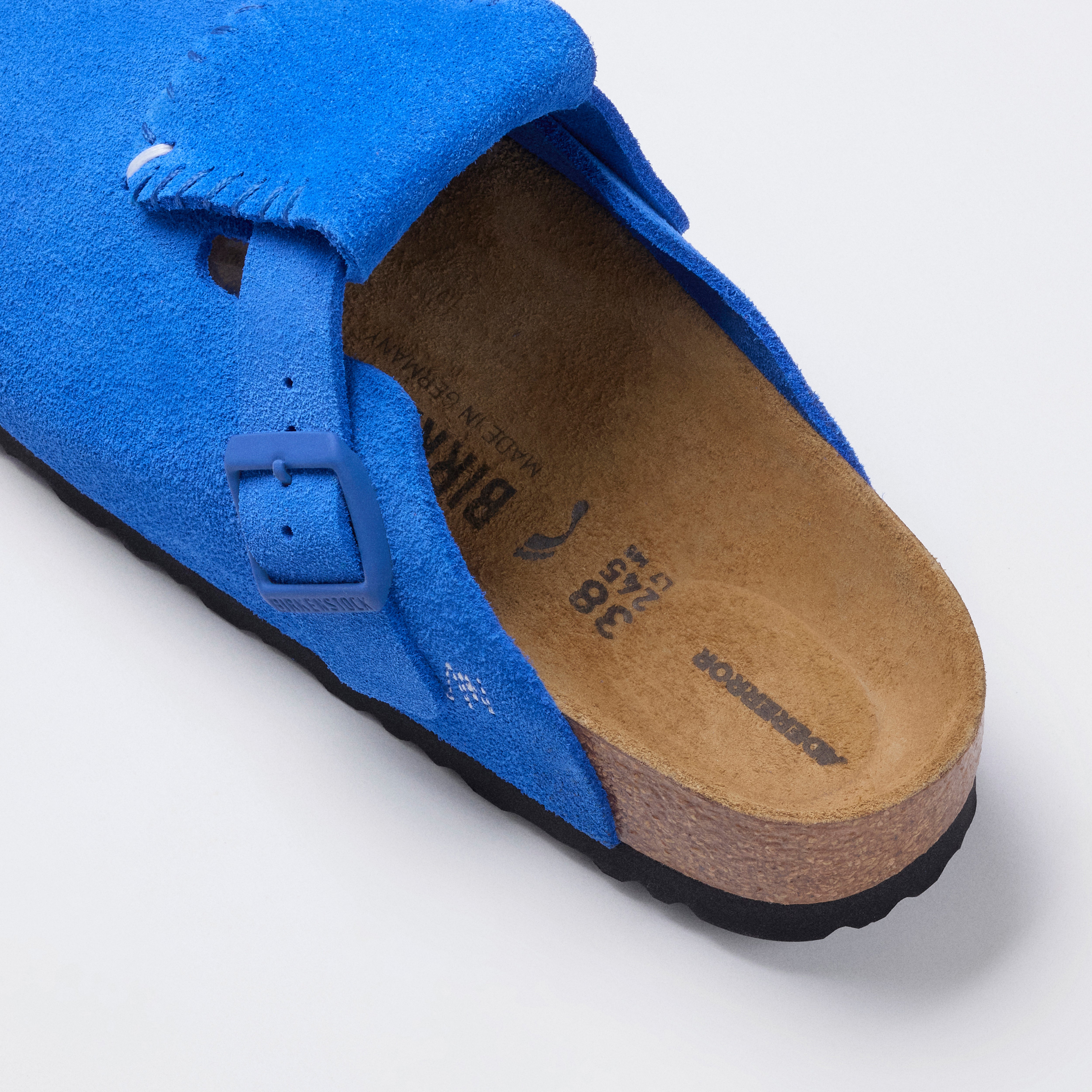 blue and black sandals on a white background 