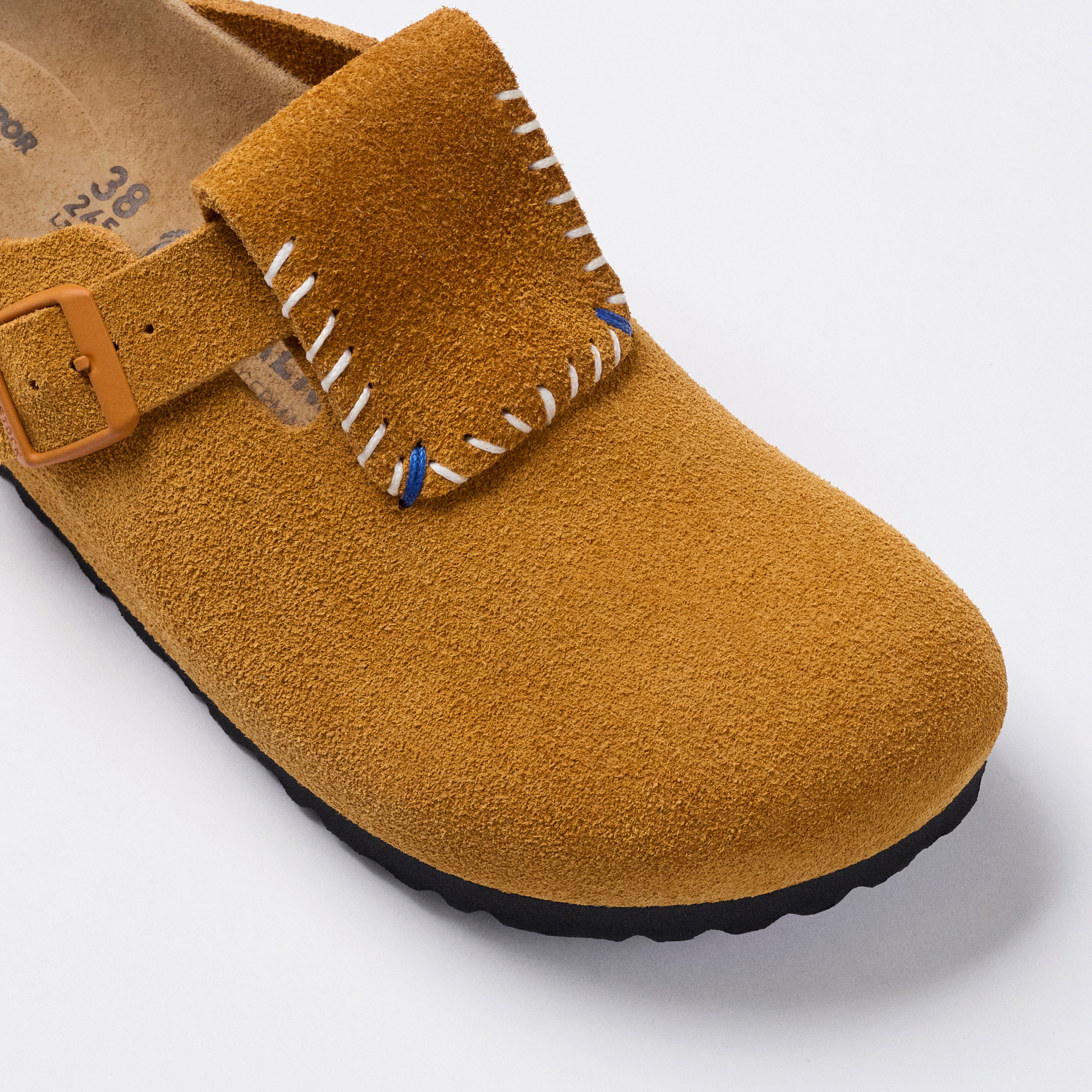 honey tan and black sandals on a white background 