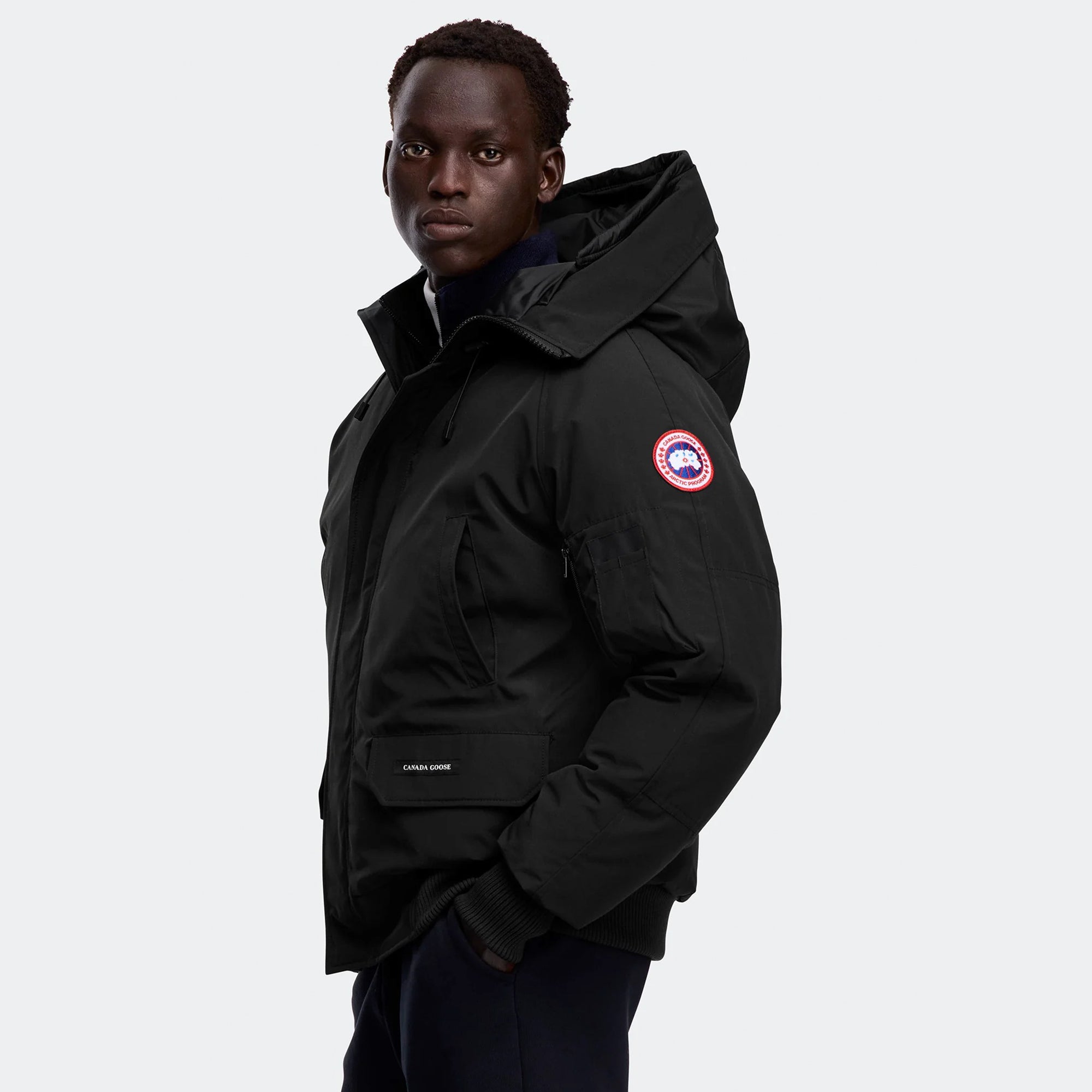 person wearing a black jacket on a white background