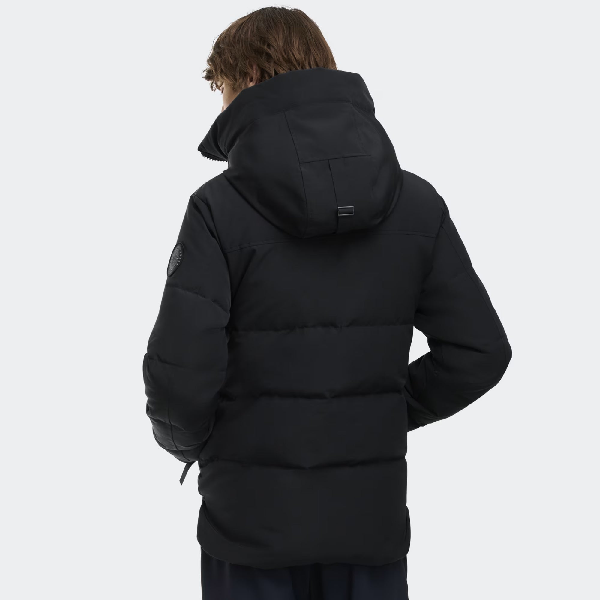 person wearing a black jacket on a white background