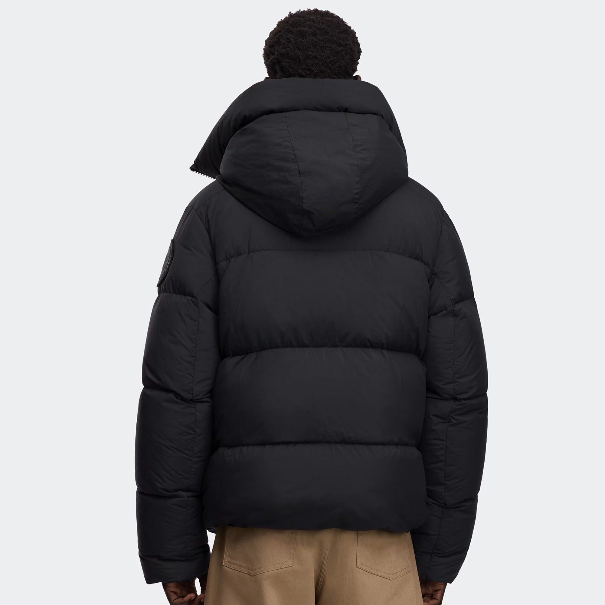 person wearing black jacket on a white background