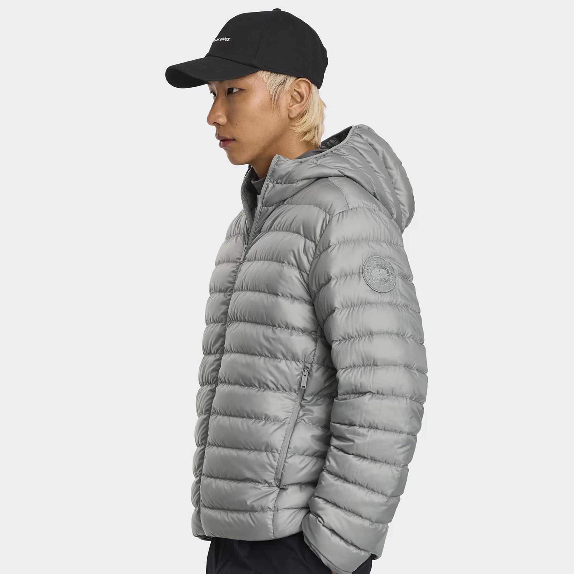person wearing a grey jacket on a white background