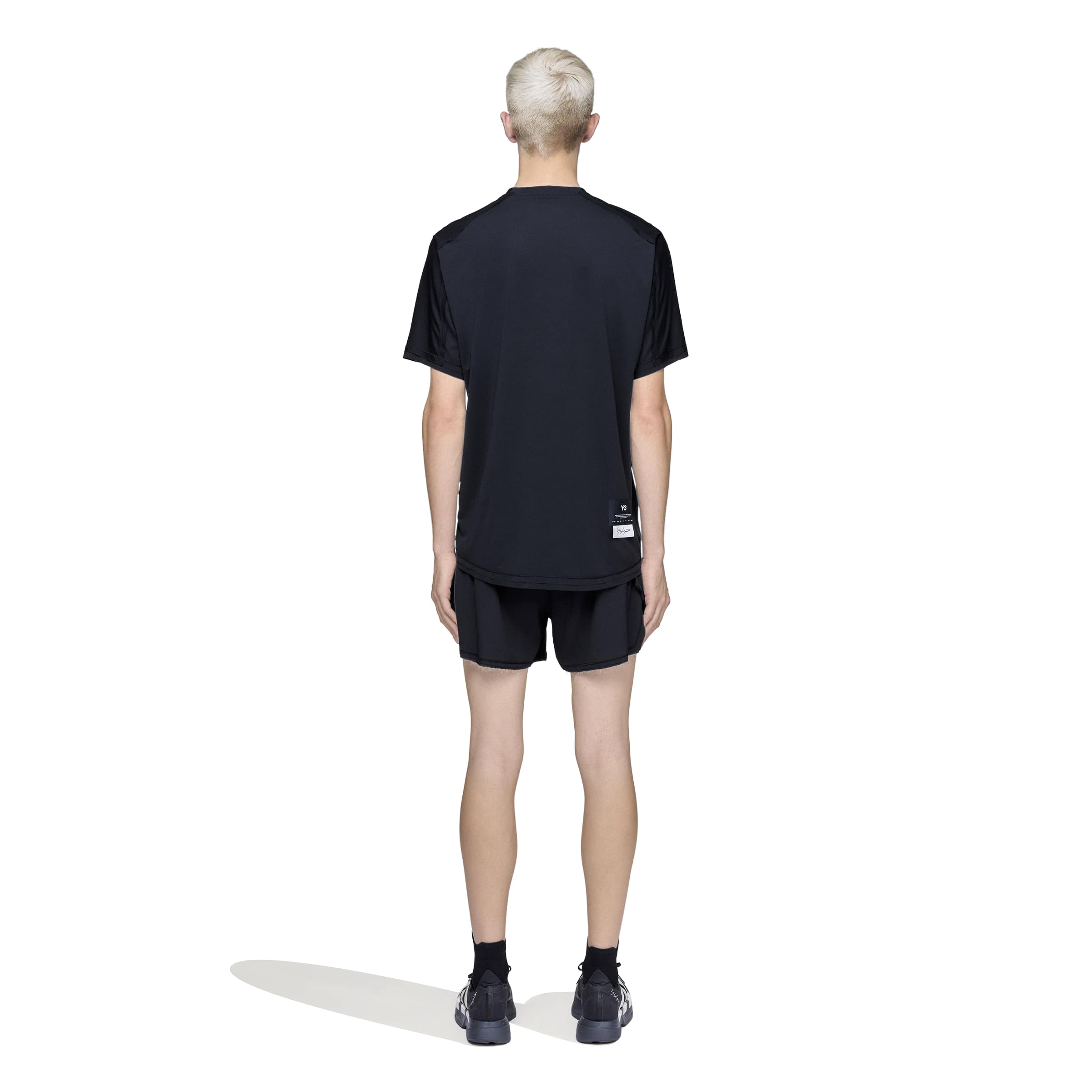 person wearing a black t-shirt on a white background