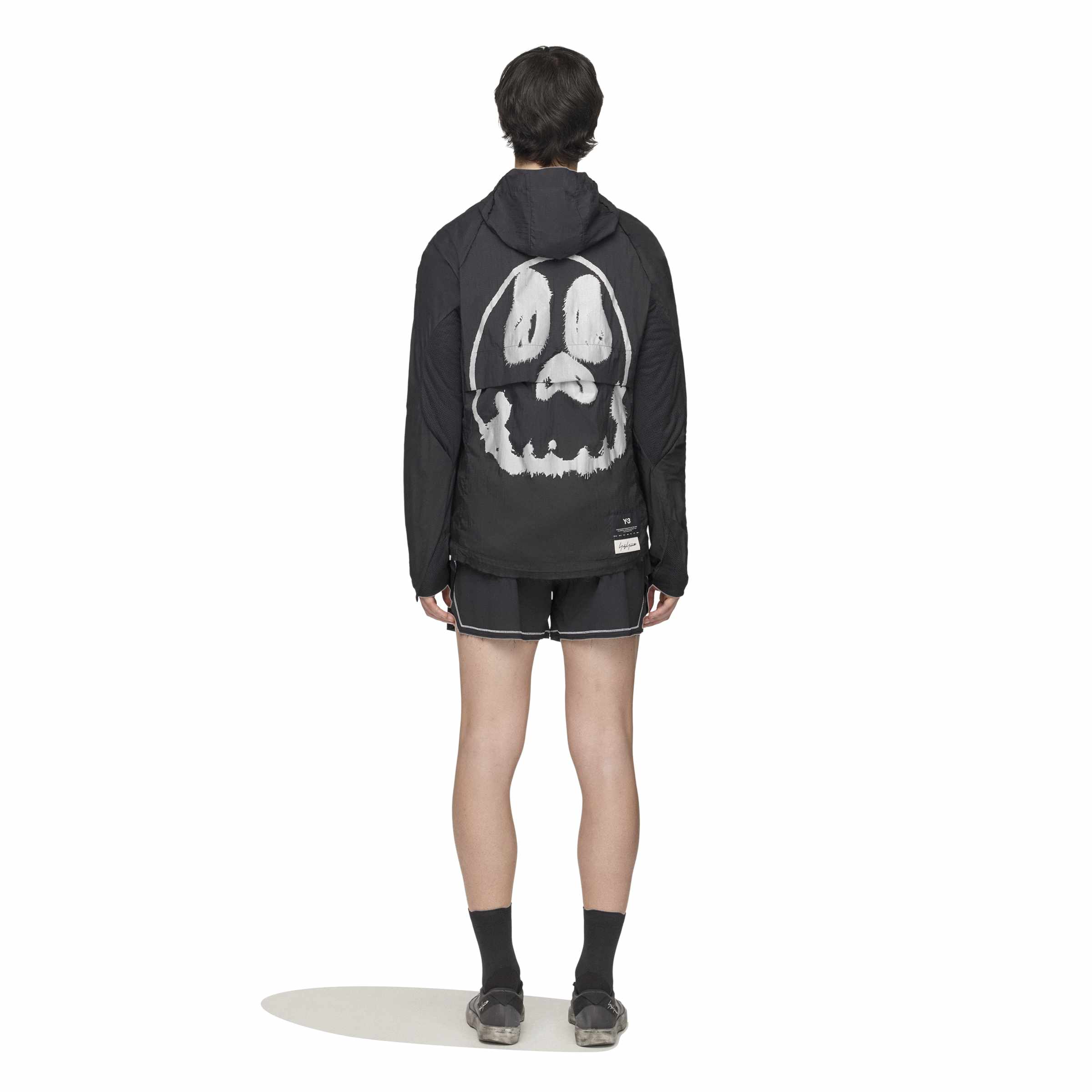 person wearing a black and white jacket on a white background