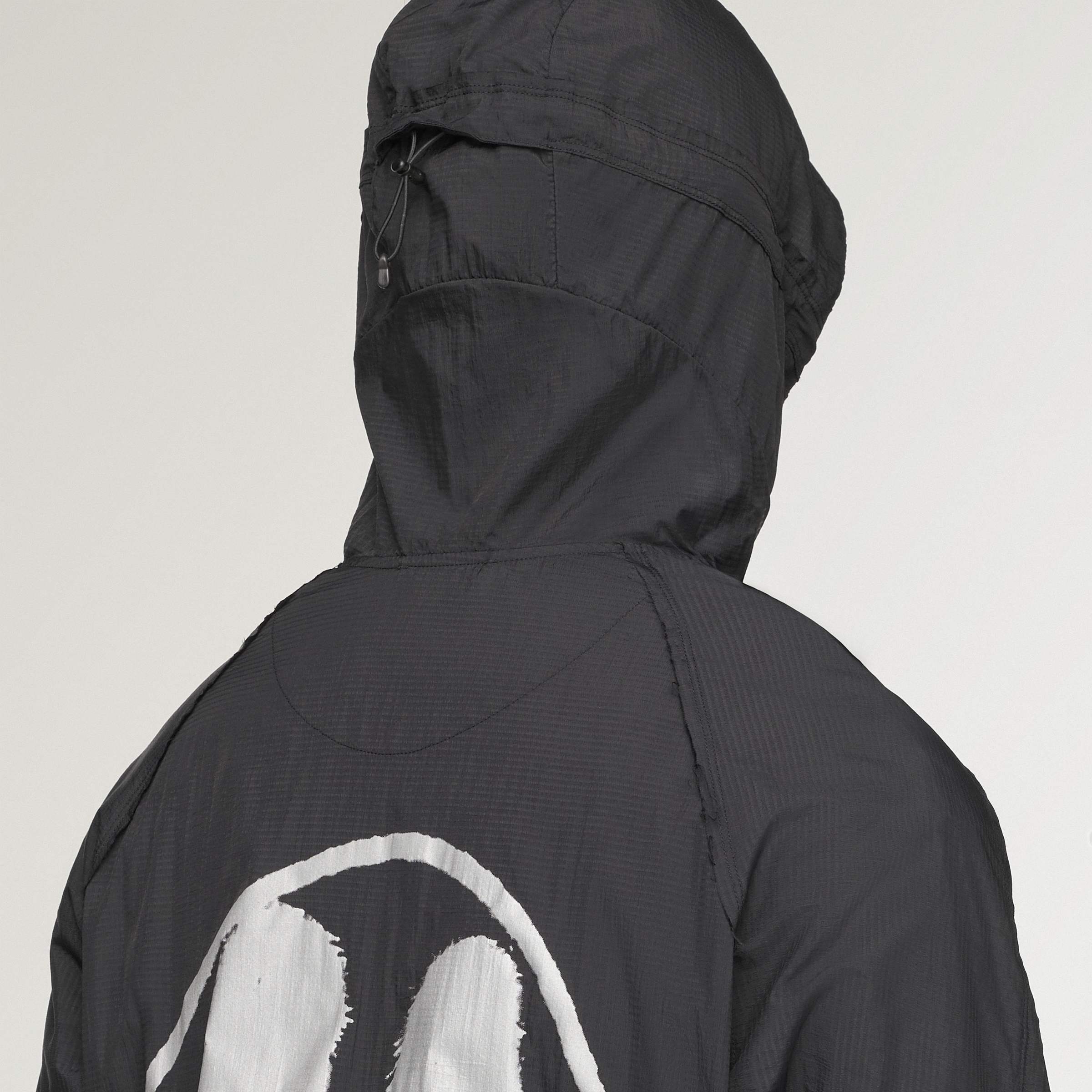 person wearing a black and white jacket on a white background