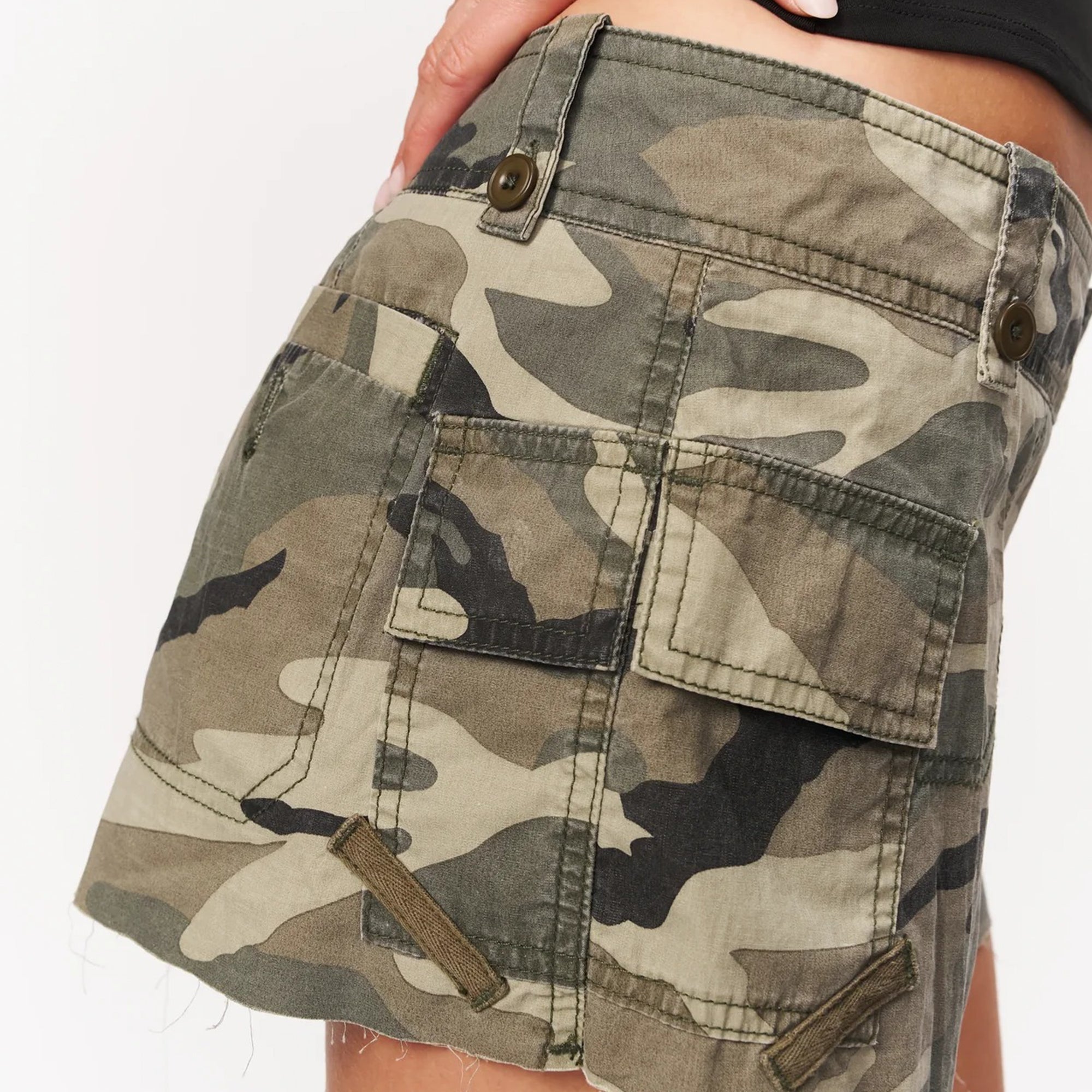 person wearing a camo cargo skort on a white background